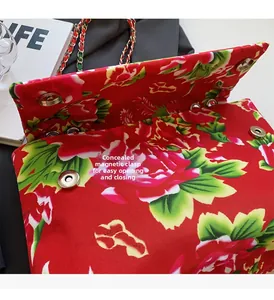Detail view of double invisible magnetic buckles on floral canvas crossbody bag