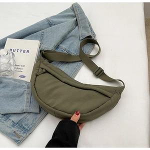 Detail of army green nylon crescent bag with adjustable strap and smooth zipper closure