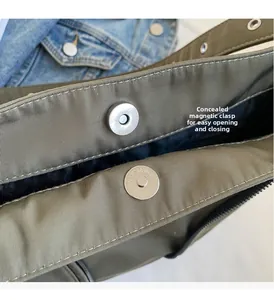 Detail of army green shoulder bag showing the internal invisible magnetic snap closure