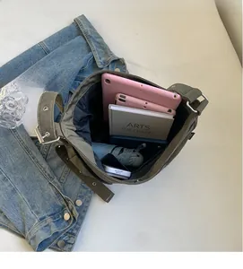 Top view of olive green crossbody bag showing large capacity for tablet and daily items