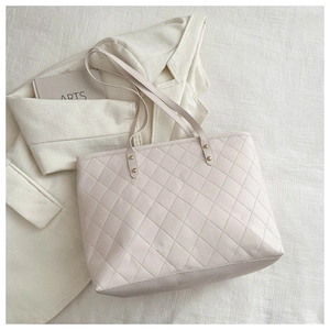 Quilted beige PU leather tote bag for women with golden studs and stylish urban design