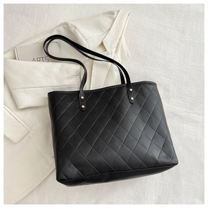 Chic black quilted PU leather tote bag with gold rivets for stylish urban women