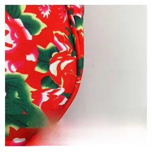 Detail of red floral nylon fabric showing heavy-duty stitching and reinforced piping edge
