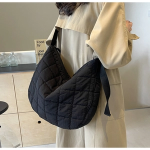 Detail of black quilted puffer hobo bag showing the lightweight water-resistant nylon fabric