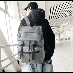 Side view of gray matte PU backpack showing spacious compartments and adjustable straps