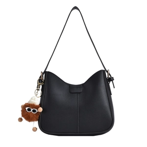 Minimalist black PU leather crescent shoulder bag with cute monster plush charm