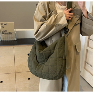 Close-up of olive green quilted hobo bag with adjustable wide strap and diamond pattern