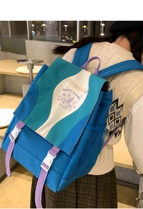 Close-up of vibrant nylon backpack with colorful patchwork, ufo print, and side mesh pocket