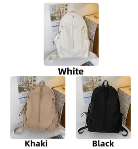 Nylon waterproof backpacks in white, khaki and black featuring a unique vertical zipper detail