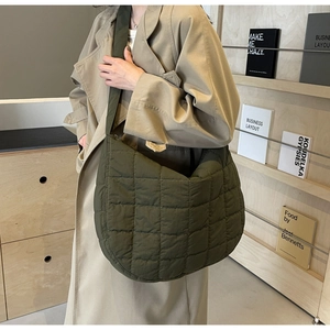 Quilted nylon crescent bag in army green showing large capacity and soft texture