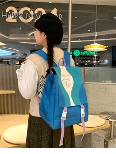 Detail of multi-color nylon backpack with buckle closure and casual graphic design
