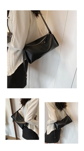 Detail of minimalist black PU leather crossbody bag with smooth texture and metal zipper