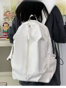 Detail of white nylon backpack featuring vertical zipper and woven cord pulls for women