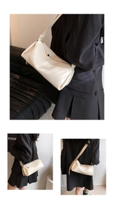 Detail of a chic cream-white PU leather shoulder bag with embossed texture and strap