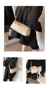 Close-up of cream PU leather shoulder bag featuring embossed logo and metal zipper hardware