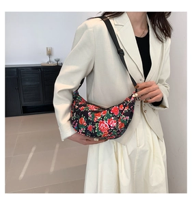 Floral hobo bag styled with a beige blazer and white skirt in a minimalist interior