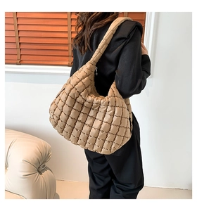 Detailed back view of a brown quilted cotton crossbody bag with soft padded straps