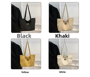 Detail view of canvas tote bags in black, khaki, yellow, and white colors