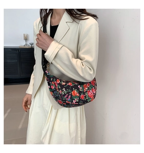 Detail of floral moon bag showing vintage rose pattern on black canvas material