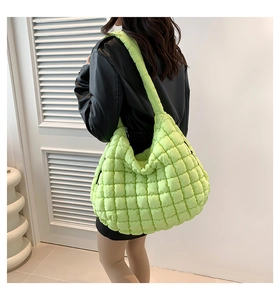 Macro shot of large fluorescent green quilted puffer bag with textured bubble design