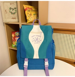 Detailed close-up of multi-color nylon backpack with contrast straps and illustration