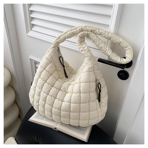 White quilted cloud hobo bag made of lightweight cotton fabric on a black chair