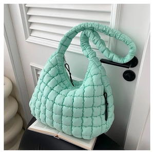 Chic mint green quilted puffer crossbody bag in lightweight cotton for spring 2024 fashion