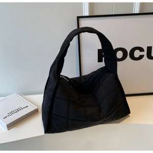 Minimalist black quilted canvas shoulder bag with puffed hobo design and zipper closure