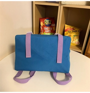 Detailed shot of durable blue nylon fabric with contrasting light purple strap and buckle