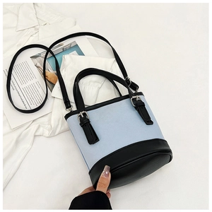 Modern light blue and black bucket bag with adjustable strap and dual handles