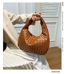 Detailed view of brown woven leather texture on a stylish Hobo bag for women