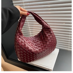 Close-up of deep wine red woven PU leather hobo bag with intricate craft detail