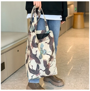 Off-white canvas tote bag featuring elegant crane print pattern and wide handles