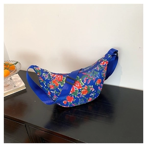Blue floral nylon shoulder bag with crescent shape and adjustable wide strap
