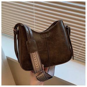 Brown vintage PU leather crossbody bag with a trendy colorful woven wide shoulder strap
