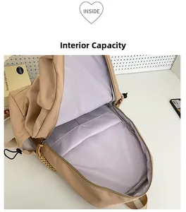 Internal capacity view of beige nylon backpack showing padded laptop sleeve and printed lining