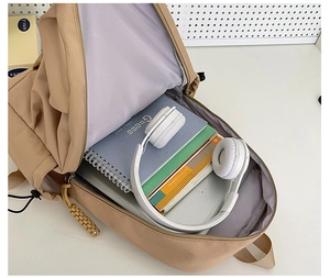 Close-up of khaki nylon backpack interior showing padded laptop sleeve and large capacity