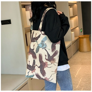 Detail view of stylish canvas tote bag with traditional Chinese crane art pattern print