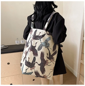 Detail of canvas tote bag featuring elegant crane print patterns for a modern fashion look