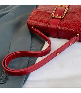 Detailed close-up of a red crocodile texture PU leather handbag with gold metal chain link