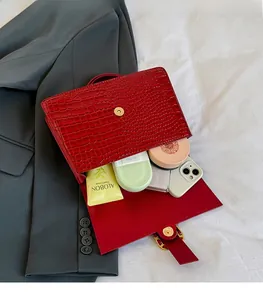 Detail of red crocodile pattern PU handbag showing spacious interior for essentials