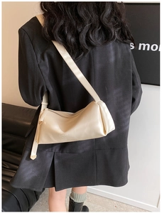 Fashionable beige PU leather crossbody bag shown on a model from a back perspective