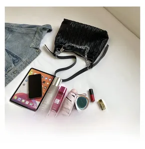 Interior capacity of black pleated PU crossbody bag with gadgets and cosmetics