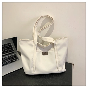 Minimalist off-white canvas shoulder bag with trapezoid design for daily office use