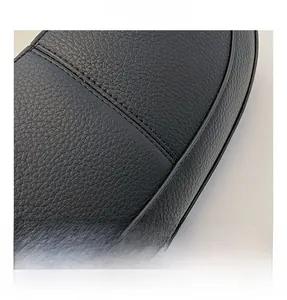 Close-up of black litchi grain PU leather texture and neat double stitching detail