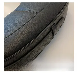 Close-up of litchi grain PU leather texture with precision double stitching on handbag