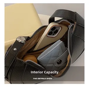 Top view of black lychee grain crescent bag interior showing spacious storage capacity
