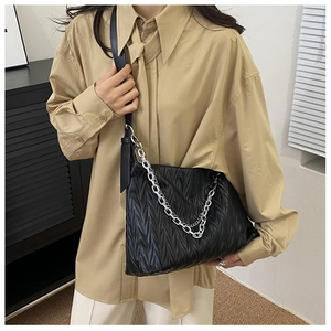 Detail view of black PU leather shoulder bag featuring pleated texture and silver chain