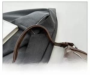 Detail showing the adjustable wide shoulder strap and vintage distressed PU leather texture