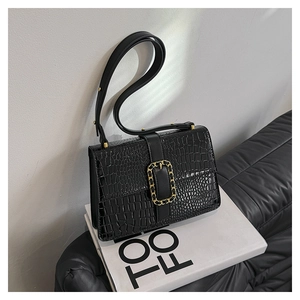Chic black crocodile-embossed leather handbag with gold chain buckle and strap